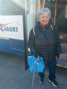 Carmon Bonano stands outside a Jaunt bus.